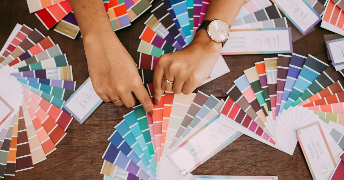 Designer selecting colors from printed palettes