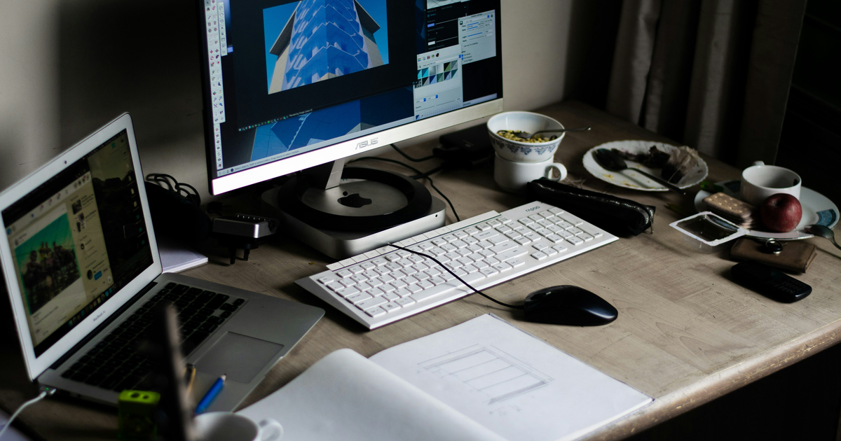 Website design workspace with monitor and sketches